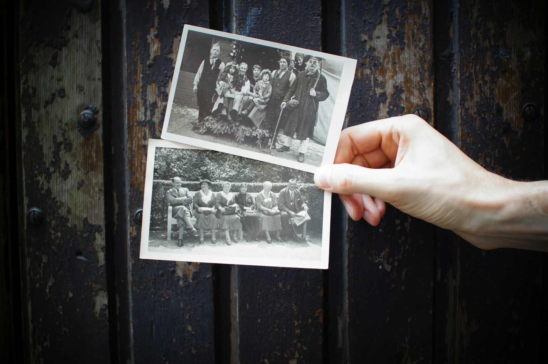 Hands holding vintage family photographs